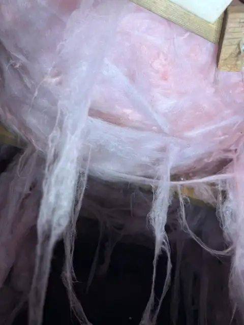 Fiberglass insulation hanging loose from the subfloor in a Lowell NC crawl space